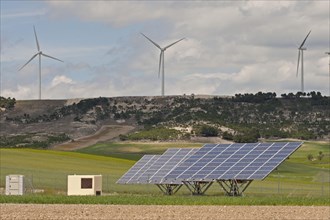 Solar energy panels and wind turbines on open plains