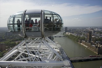 Ferris wheel passenger pods overlooking the city river