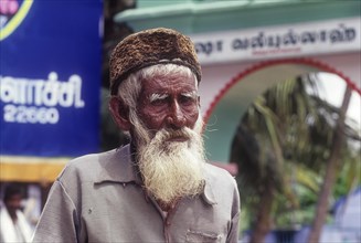 Beggar Mohammed Hanifa standing in front of a mosque