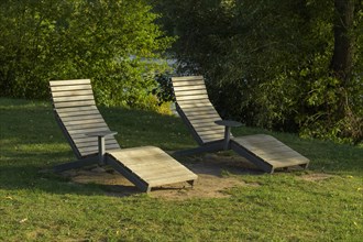 Wooden loungers on the river bank