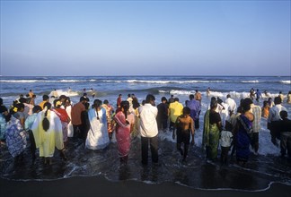People enjoying in sea water at Marina beach in Chennai
