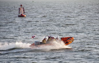 RNLI D-class inflatable lifeboat in harbour entrance