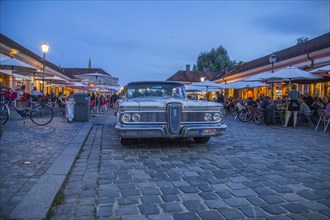 Evening scene in the Stadtamhof nightlife district with US street cruiser as eye-catcher