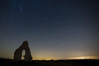 Church ruins and star trails at night