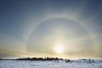 Atmospheric phenomenon sun dog caused by the interaction of light with ice crystals in the atmosphere
