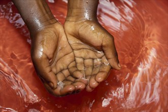 Children wash their hands in fresh