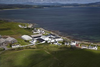 Aerial view of coastline with village and whisky distillery