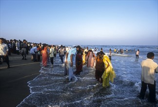 People enjoying in sea water at Marina beach in Chennai