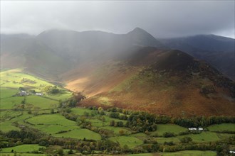 View of valley and fall with rain gusts overhead