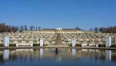 Sanssouci Palace in March with wooden panelling on the figures around the fountain in front of the flight of steps