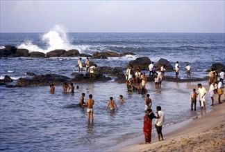 People enjoying in sea water along the shores of the three oceans at kanyakumari