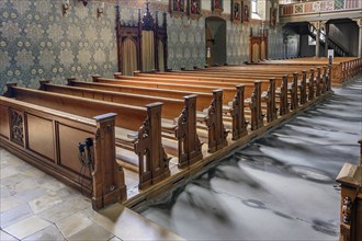 Two confessionals and rows of benches for boys and men with carvings