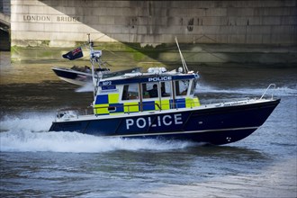 Police patrol boat patrolling city river