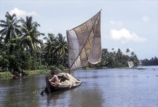 A boat man carrying sand on a dhow