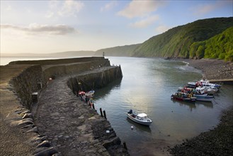 View of harbour wall and fishing boats in early morning