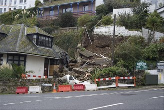 Landslide with van buried under debris in a coastal town
