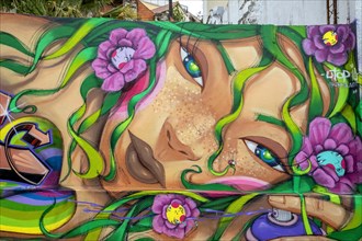 Female face wall art by Utopia in Mouraria