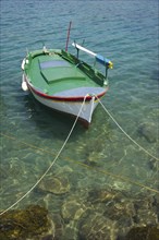 Small fishing boat moored in shallow water