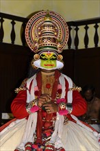 Fully made up and costumed Kathakali dancer performing