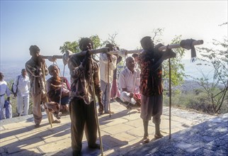 Pilgrims being carried in makeshift wooden chair