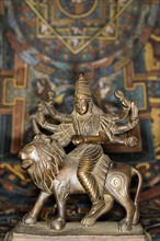Bronze figure of the Indian goddess Durga riding on a lion figurine
