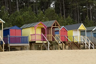 Colourfully painted beach huts at Holkham Bay near Wells by the Sea