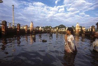 A girl worshipping Navagraha idols