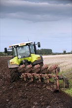 Claas 640 Axion tractor with five-furrow reversible plough