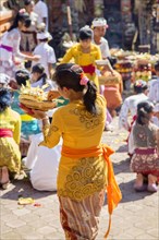 Balinese woman bringing offerings to a temple during Galungan