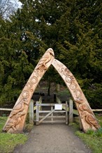 Carved wooden arch at entrance to woodland