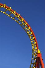 Roller coaster in front of blue sky