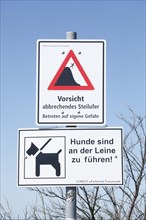 Signs caution breaking steep bank and dogs must be kept on a leash
