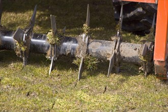 Aerating a field with a rotavater with knives to cut the soil