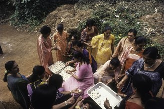 Kodava women making rice ball Kadamputtu