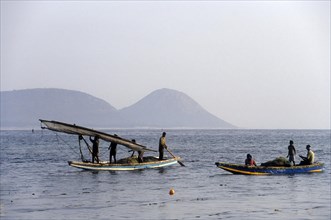 Fishermen rolling the Sailing boat cloth