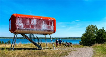 Red container at the lake that serves as a viewing platform