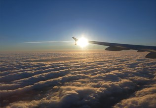Aircraft wings above the clouds