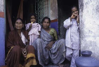Fisher women sitting infront of the house