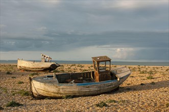 Abandoned fishing boats on a shingle beach
