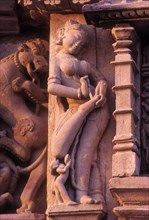 Statue of Apsaras painting her foot on Parsvanatha temple