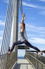 Virabhadra yoga pose balanced on a bridge