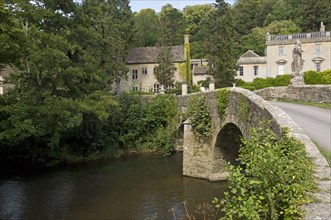 View of river and old bridge near manor house