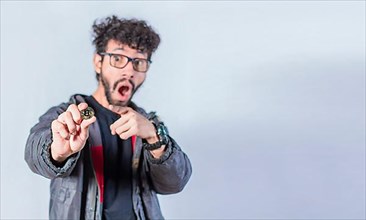 Surprised man holding bitcoin coin