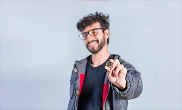 Smiling man holding bitcoin coin