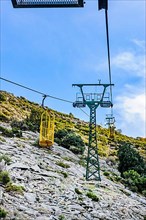 Ropeway Cabinovia Monte Capanne with open gondola Ropeway gondola standing gondola on mountain Monte Capanne