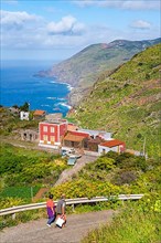 Houses in the village of El Tablado and cliffs on the Atlantic Ocean
