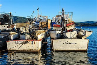 Local fishing boats moored side by side in Mediterranean harbour