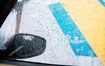 Raindrops on the side window of a car