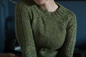 Interior shot of a woman in a knitted wool jumper