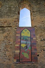 Banner and artwork with symbol for wine culture at the Stuben monastery ruins near Bremm